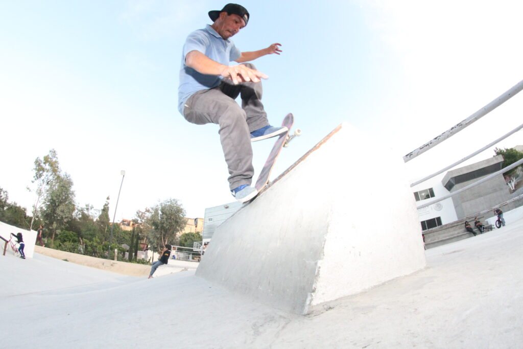 A skateboarder rider Gerardo Sosa doing a trick blunt-slide.